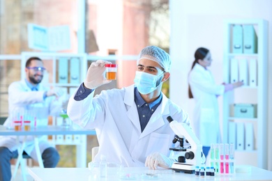 Photo of Young scientist working in laboratory. Chemical analysis