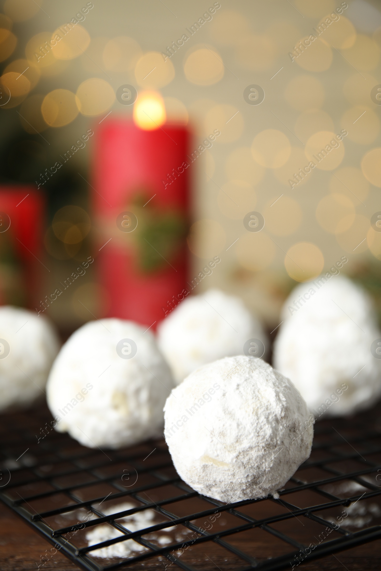 Photo of Tasty snowball cookies on cooling rack, closeup. Christmas treat