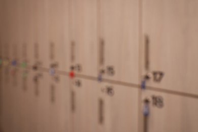 Photo of Blurred view of numbered wooden lockers with keys