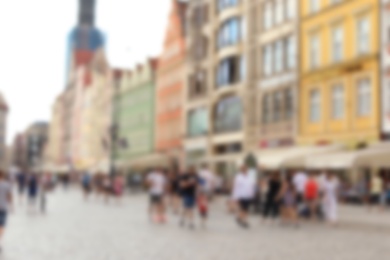Photo of Blurred view of crowded city street on sunny day