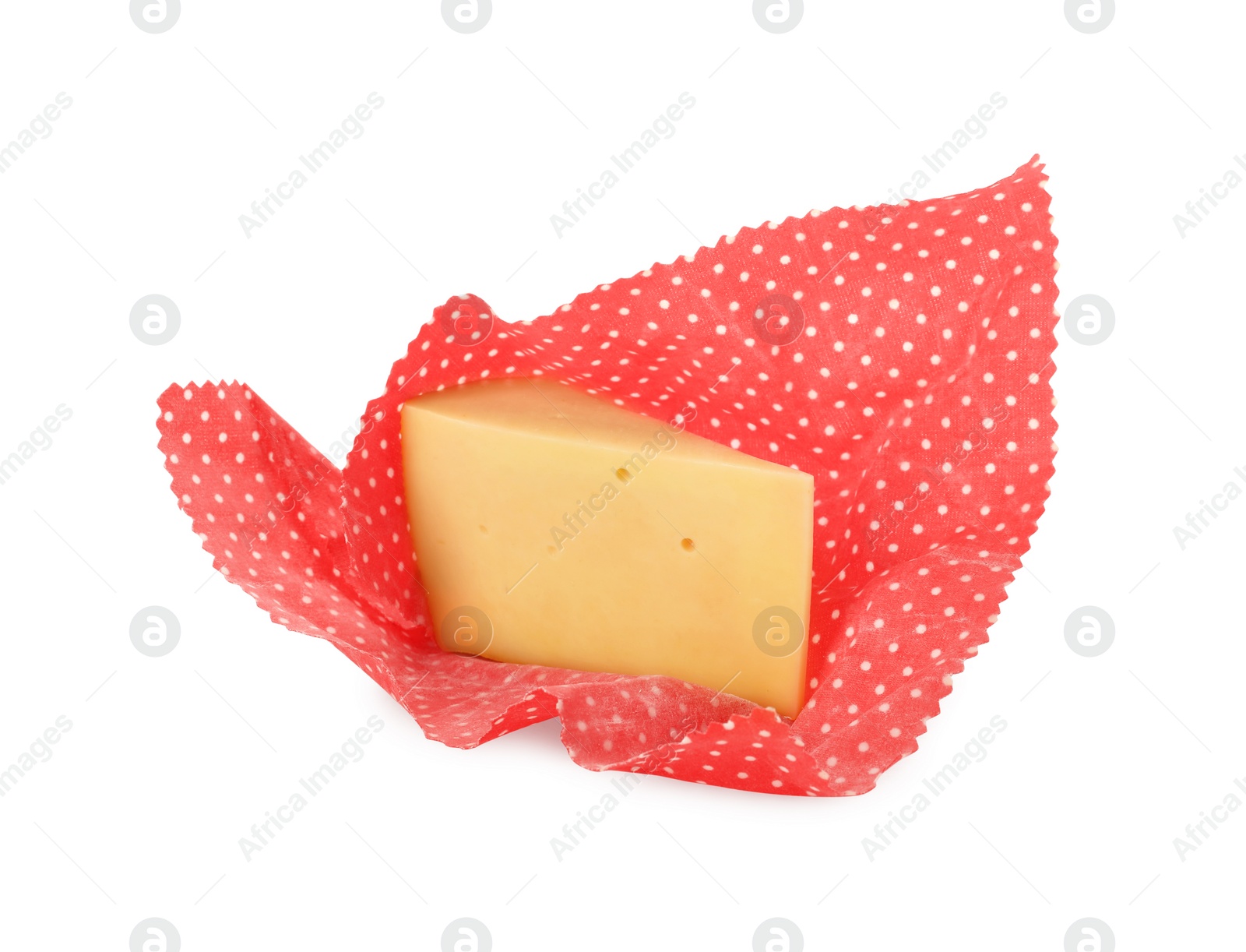 Photo of Piece of cheese in beeswax food wrap isolated on white