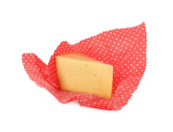 Photo of Piece of cheese in beeswax food wrap isolated on white