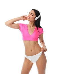 Photo of Beautiful young woman in stylish bikini with headphones on white background