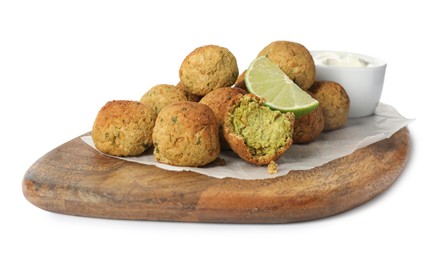 Photo of Delicious falafel balls with lime and sauce on white background