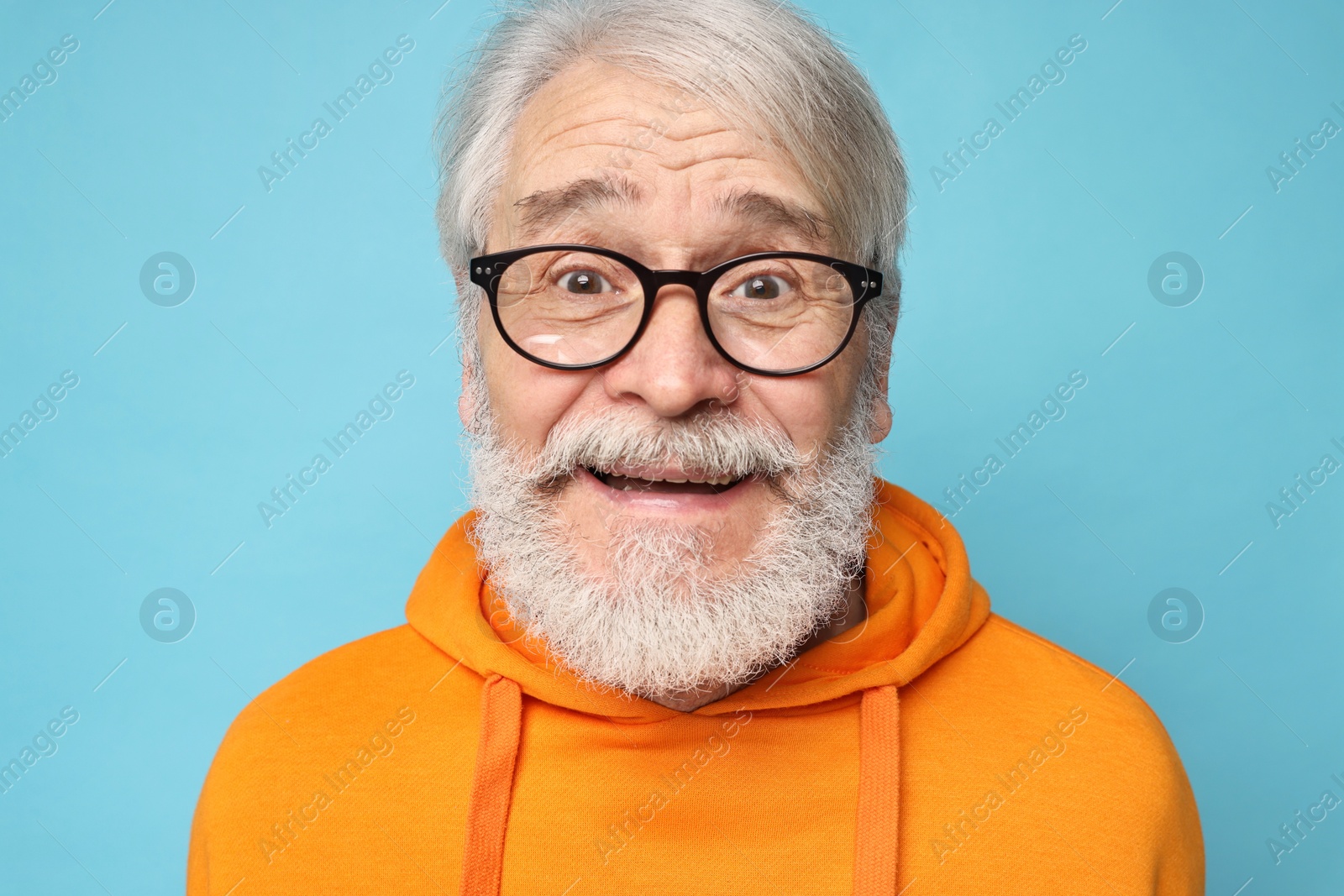 Photo of Senior man with mustache on light blue background