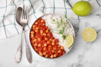 Photo of Delicious chickpea curry with rice served on white marble table, flat lay