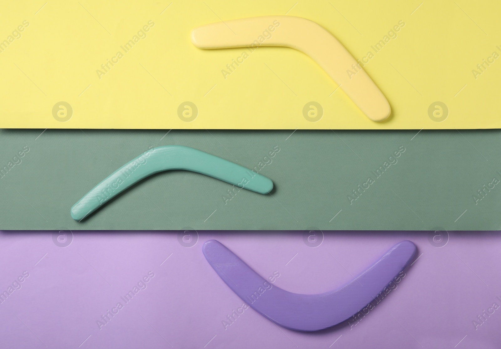 Photo of Wooden boomerangs on color background, flat lay