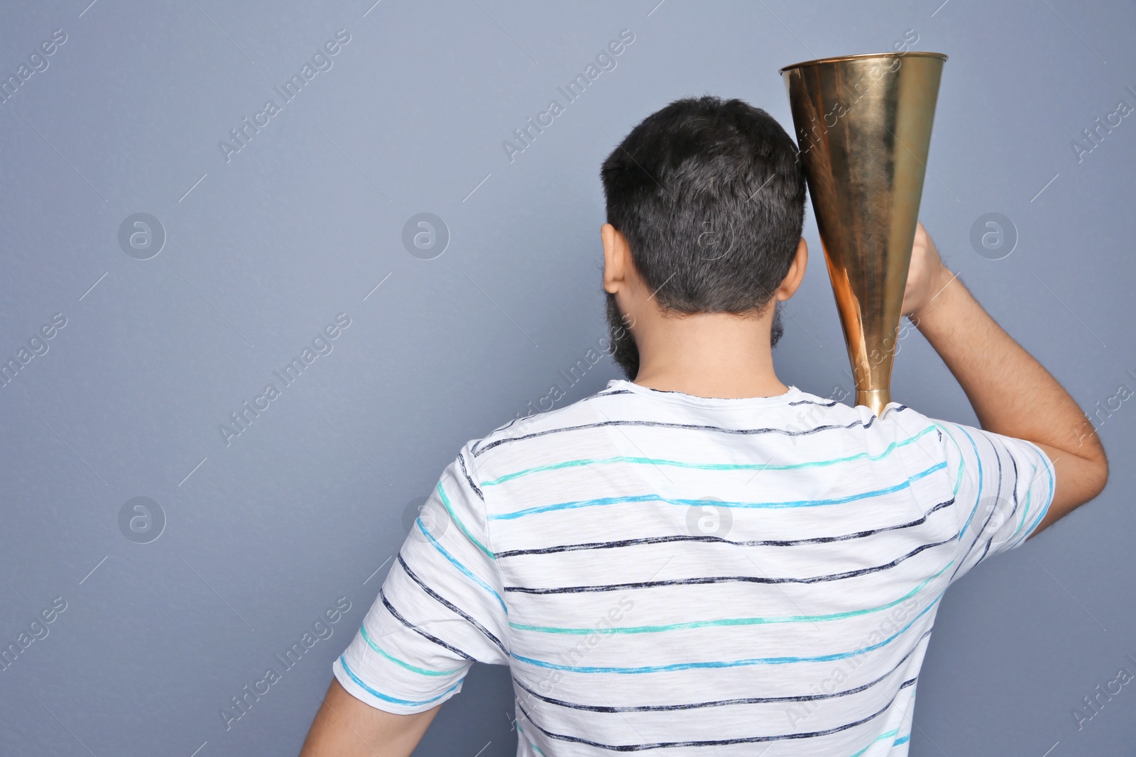 Photo of Man with megaphone on grey background