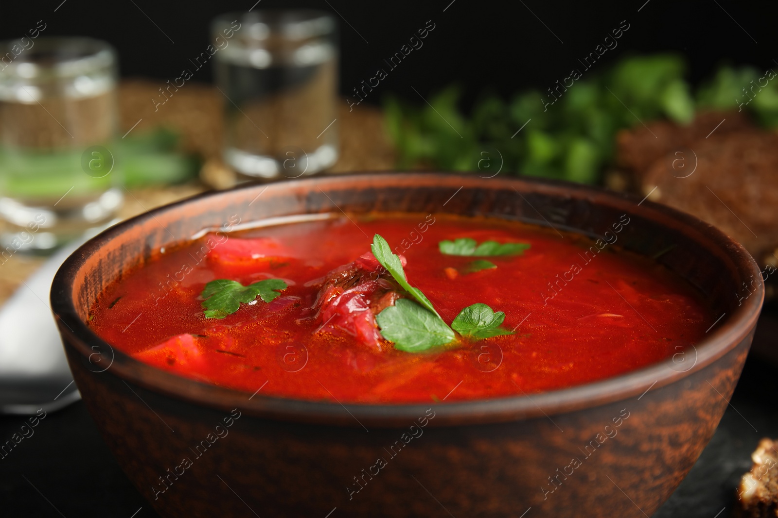 Photo of Stylish brown clay bowl with Ukrainian borsch, closeup