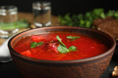 Photo of Stylish brown clay bowl with Ukrainian borsch, closeup