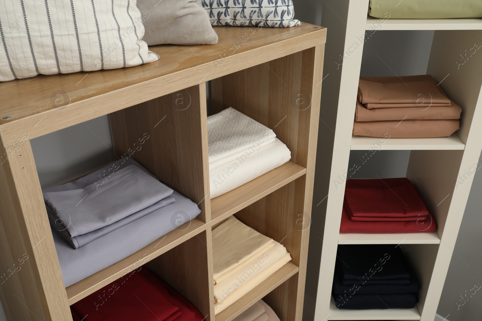 Photo of Different colorful bed linens on display in home textiles store