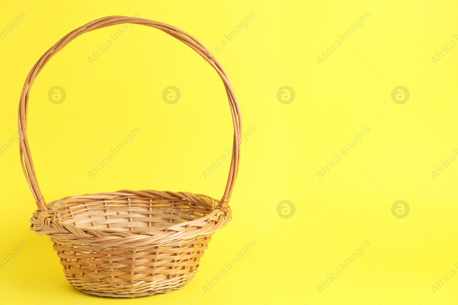 Photo of Empty wicker basket on color background, space for text. Easter item