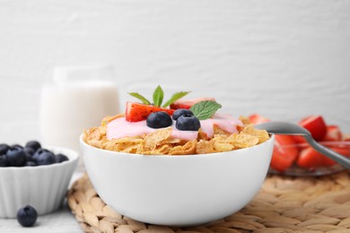 Photo of Delicious crispy cornflakes, yogurt and fresh berries in bowl on table, closeup with space for text. Healthy breakfast