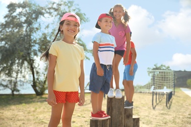 Photo of Cute children at outdoor playground on sunny day. Summer camp
