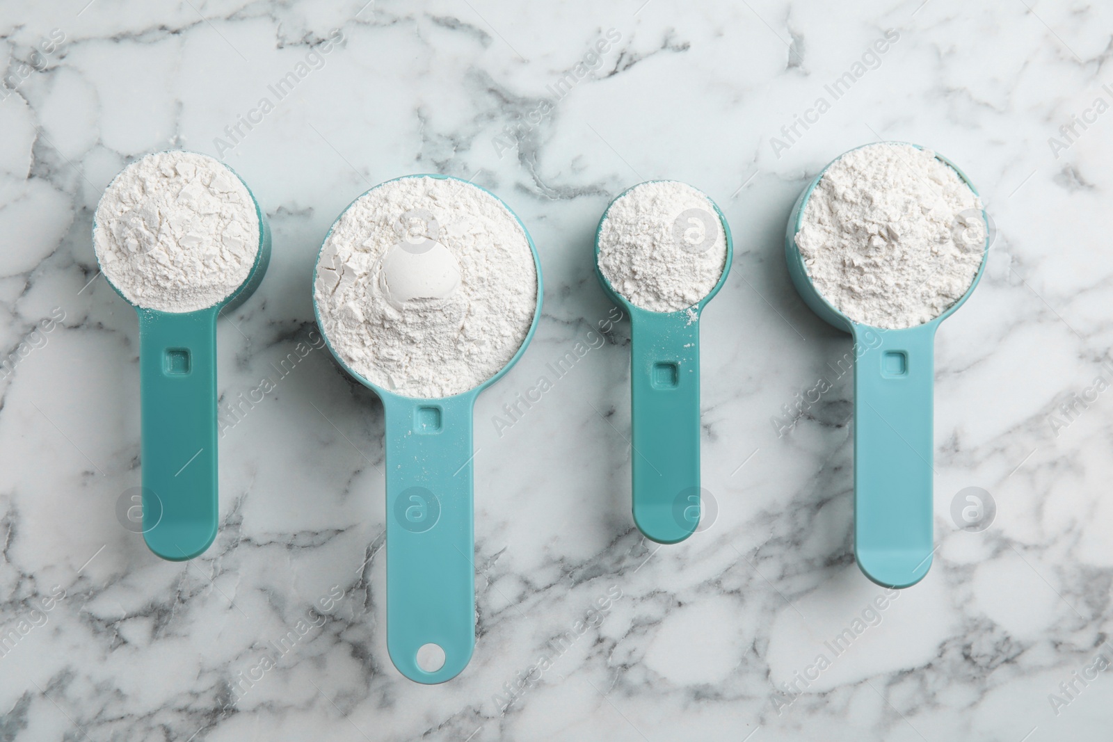 Photo of Amino acid powder on white marble table, flat lay