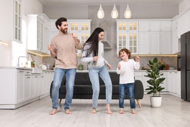 Happy family dancing and having fun at home