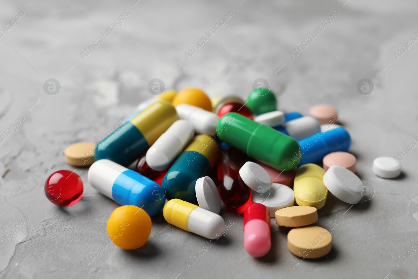 Photo of Heap of different pills on table, closeup