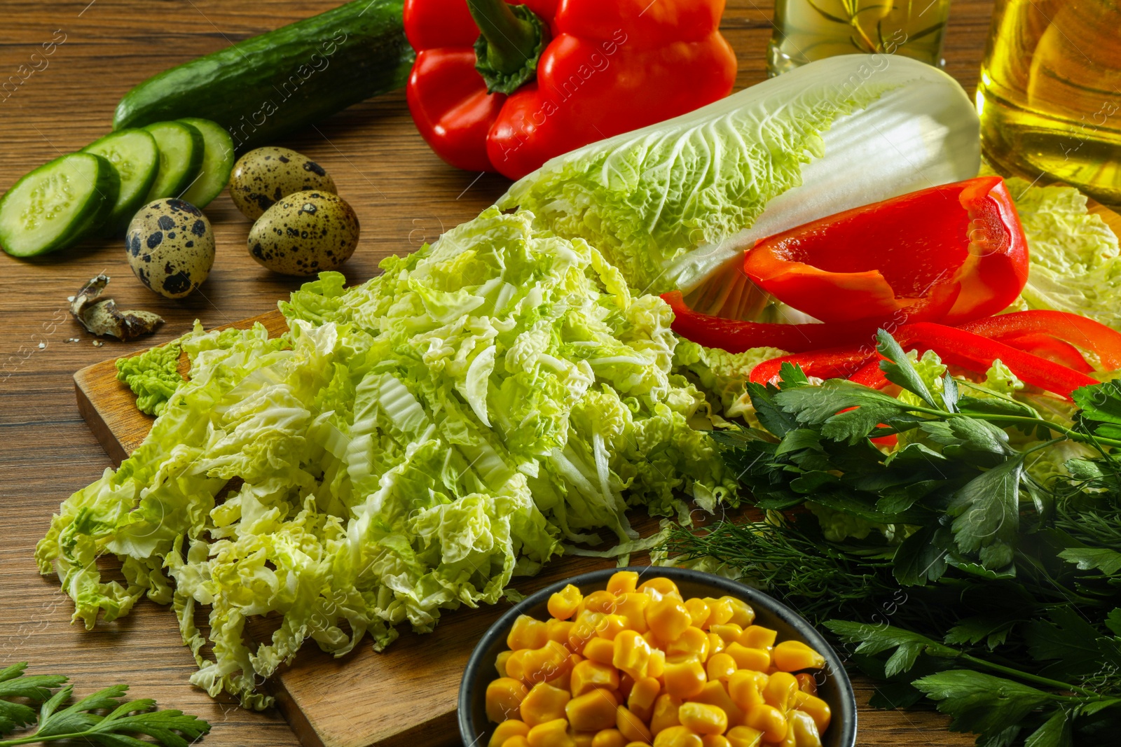 Photo of Chinese cabbage and different products on wooden table