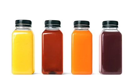 Bottles with different drinks on white background