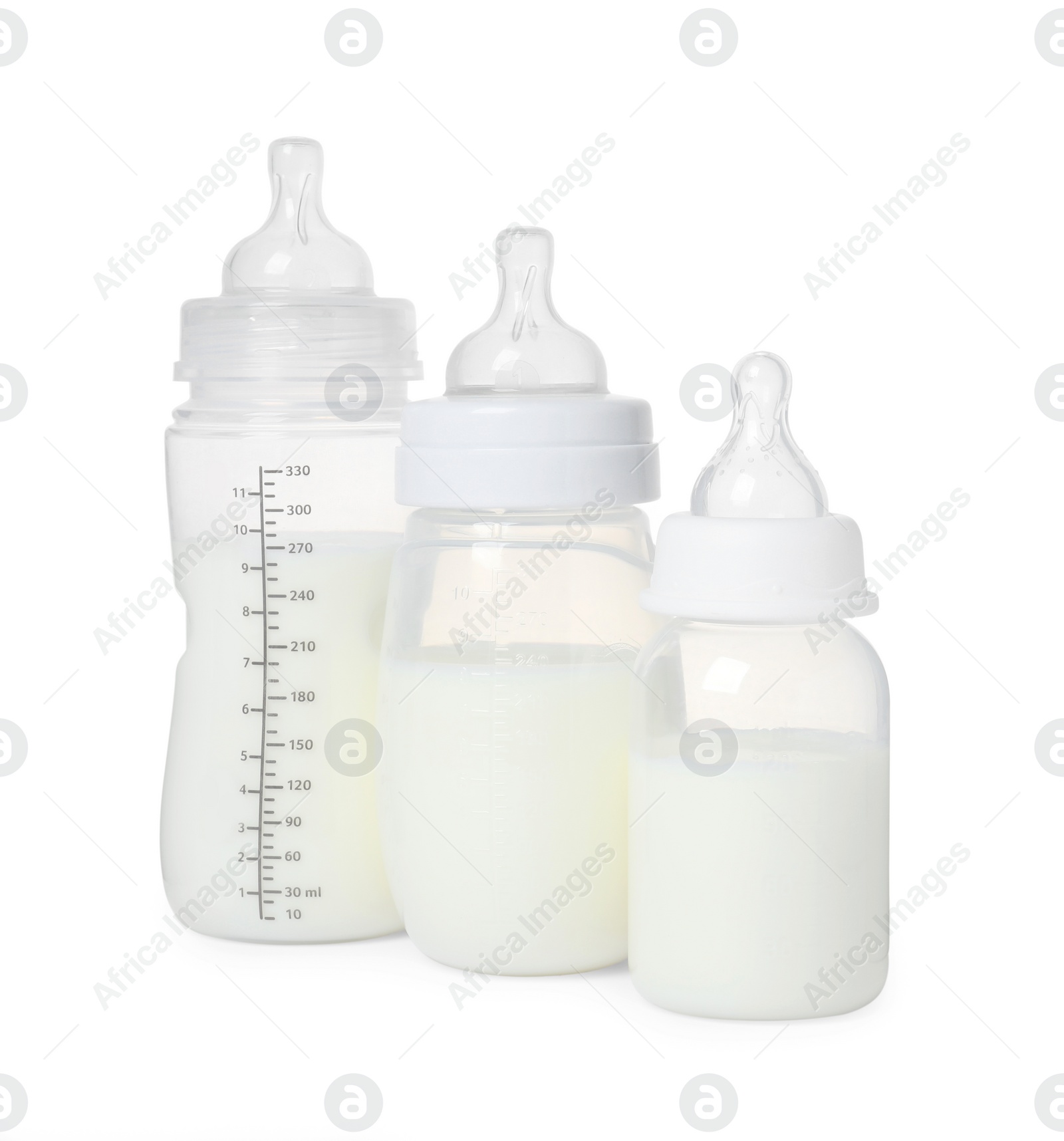 Photo of Three feeding bottles with infant formula on white background