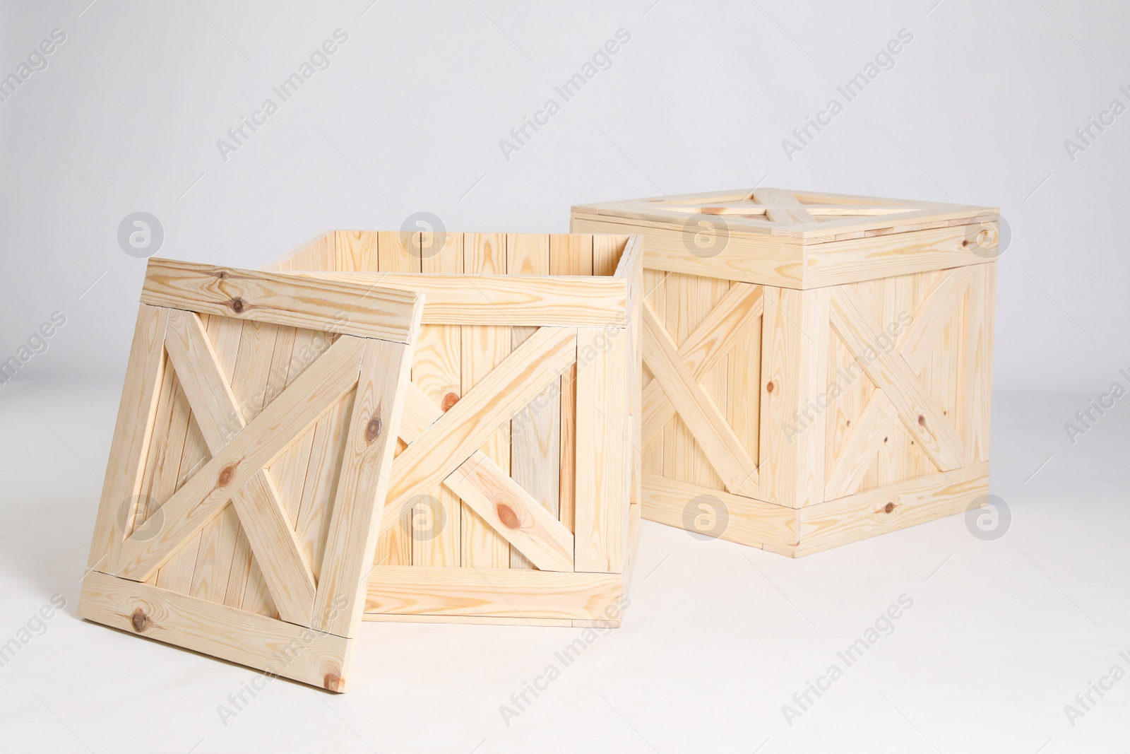 Photo of Pair of wooden crates on grey background