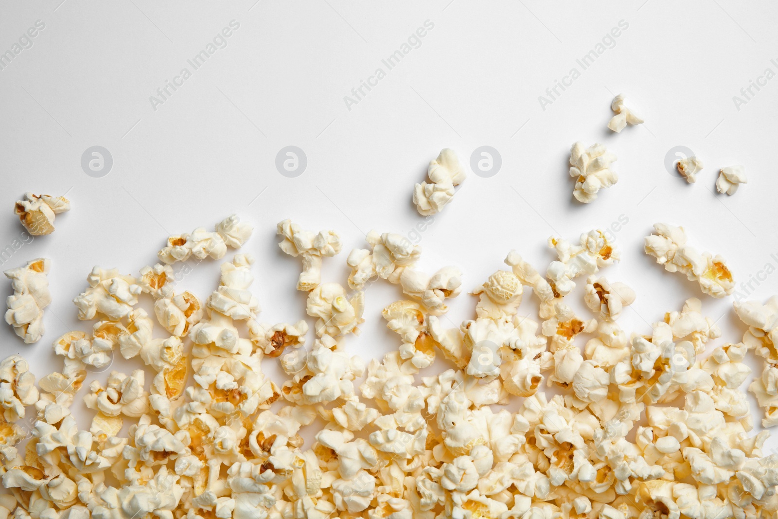 Photo of Delicious fresh popcorn on white background, top view