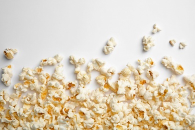 Delicious fresh popcorn on white background, top view