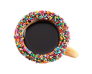 Photo of Delicious edible biscuit cup of coffee decorated with sprinkles isolated on white, top view