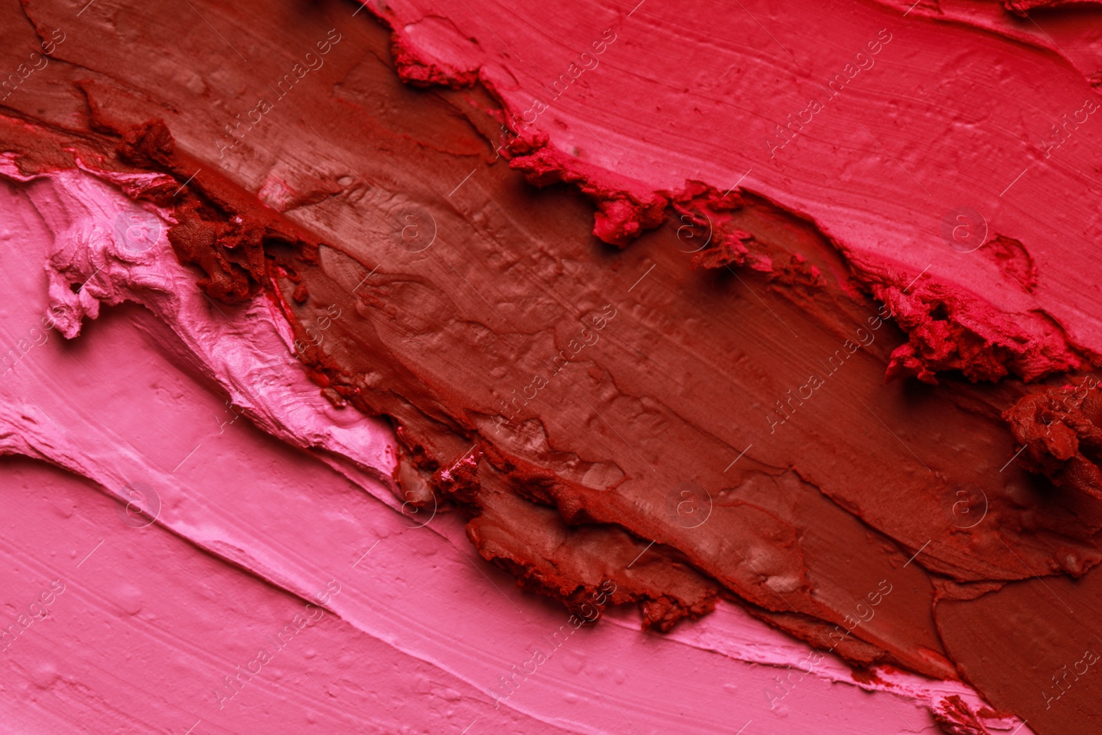 Photo of Texture of beautiful lipsticks as background, top view