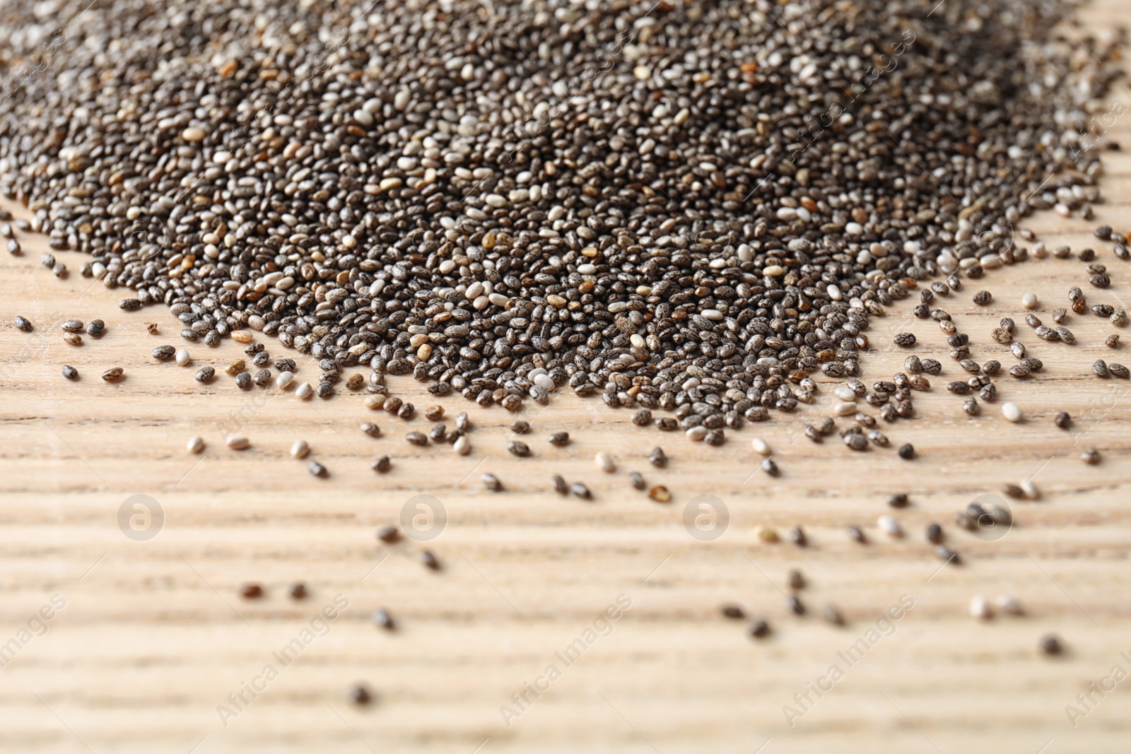 Photo of Chia seeds on wooden background, space for text