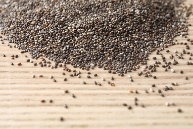 Photo of Chia seeds on wooden background, space for text