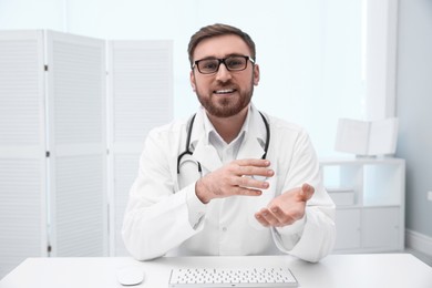 Photo of Pediatrician consulting patient using video chat in clinic, view from webcam