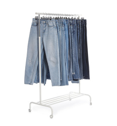 Photo of Rack with different jeans isolated on white