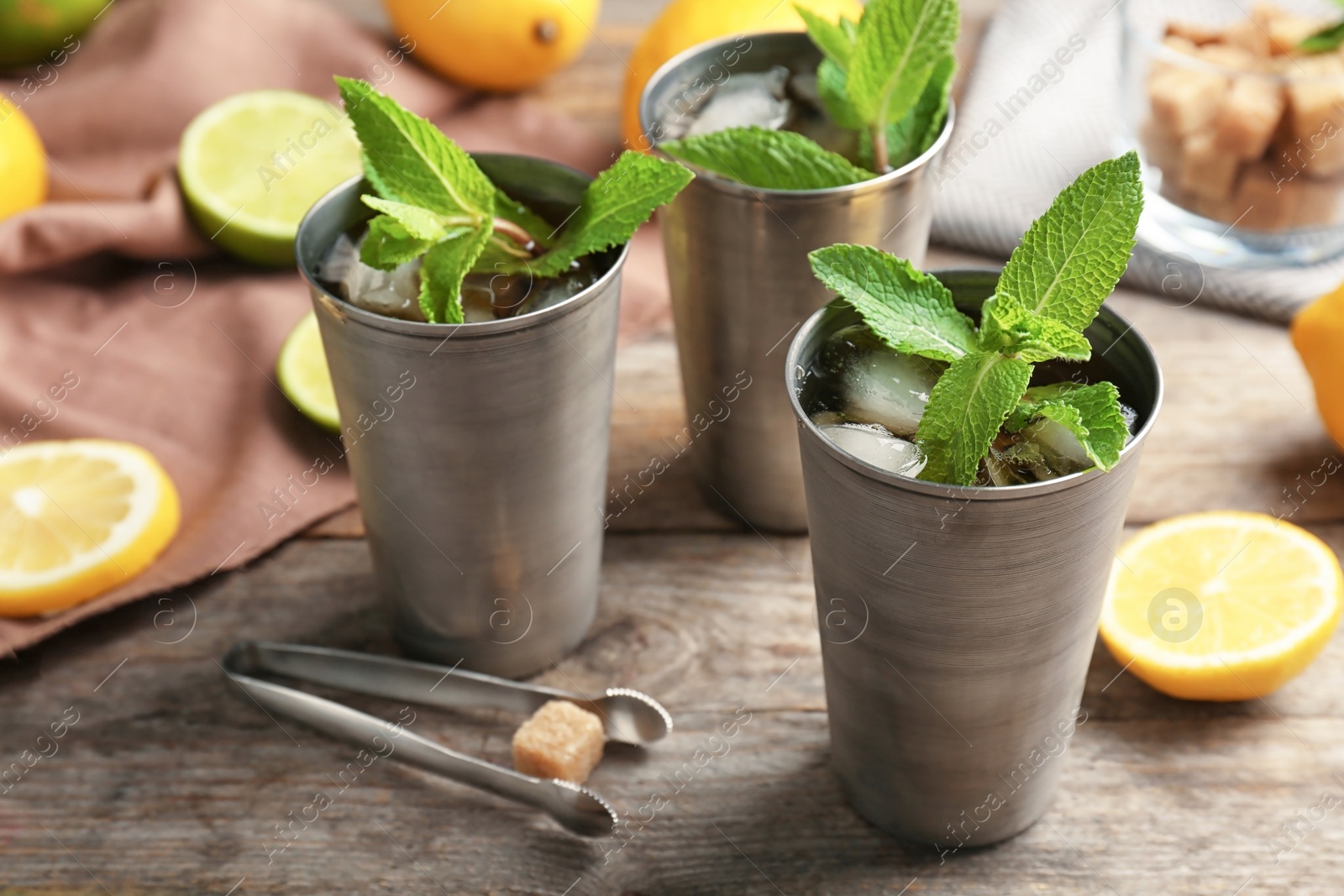 Photo of Composition with delicious mint julep cocktail on table