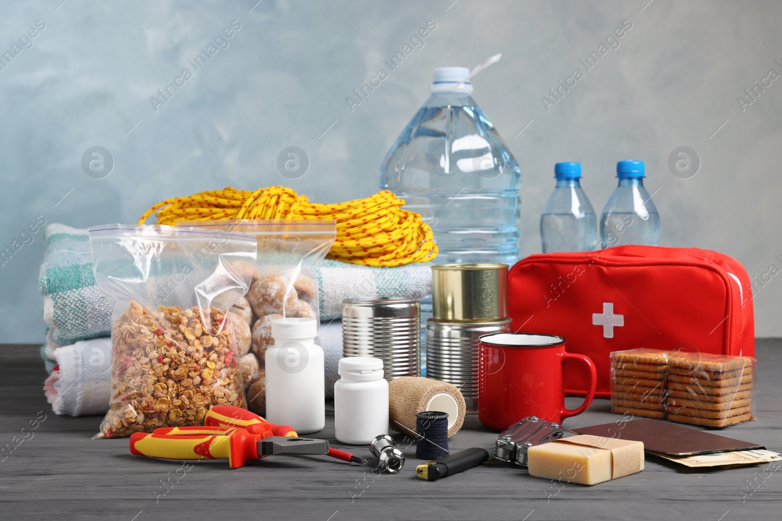 Photo of Disaster supply kit for earthquake on black wooden table