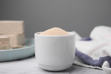 Granulated yeast in bowl on table, closeup