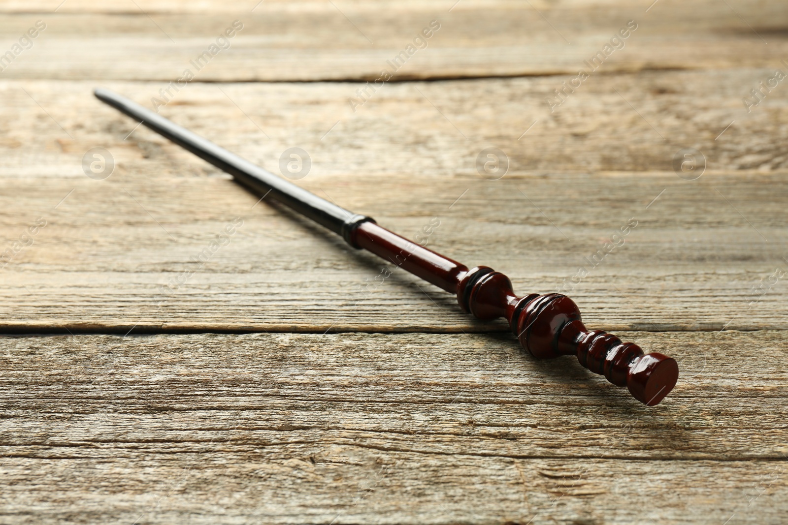 Photo of One old magic wand on wooden table