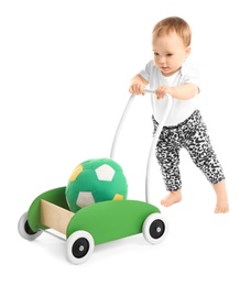 Cute baby with toy walker on white background