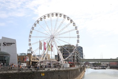 Photo of Cologne, Germany - August 28, 2022: Picturesque view of Ferris wheel in city near canal, space or text