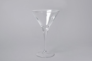 Photo of Empty clean martini glass on grey background