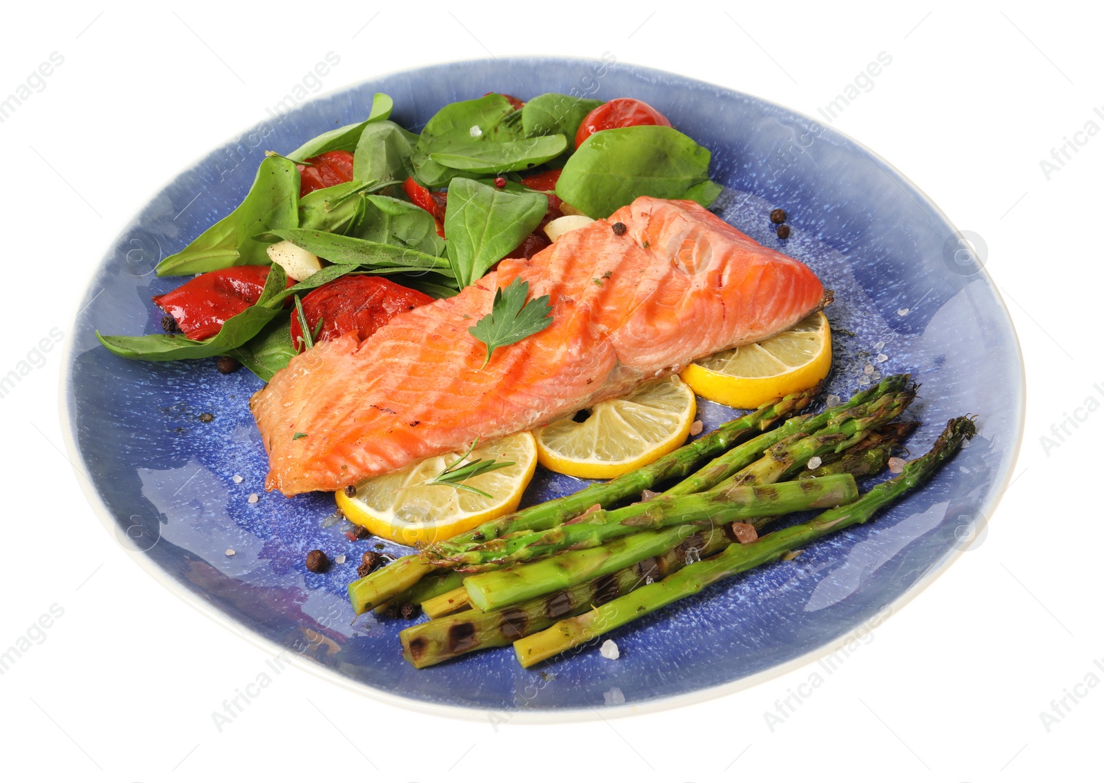 Photo of Tasty grilled salmon with tomatoes, asparagus, spinach and lemon isolated on white