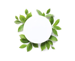 Photo of Blank card and spring green leaves on white background, top view. Space for text