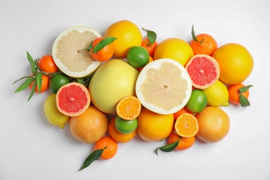 Photo of Different citrus fruits on white background, top view