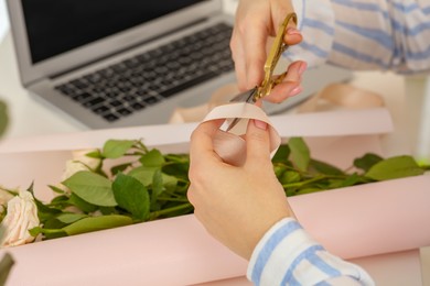 Photo of Woman making bouquet following online florist course at home, closeup. Space for text