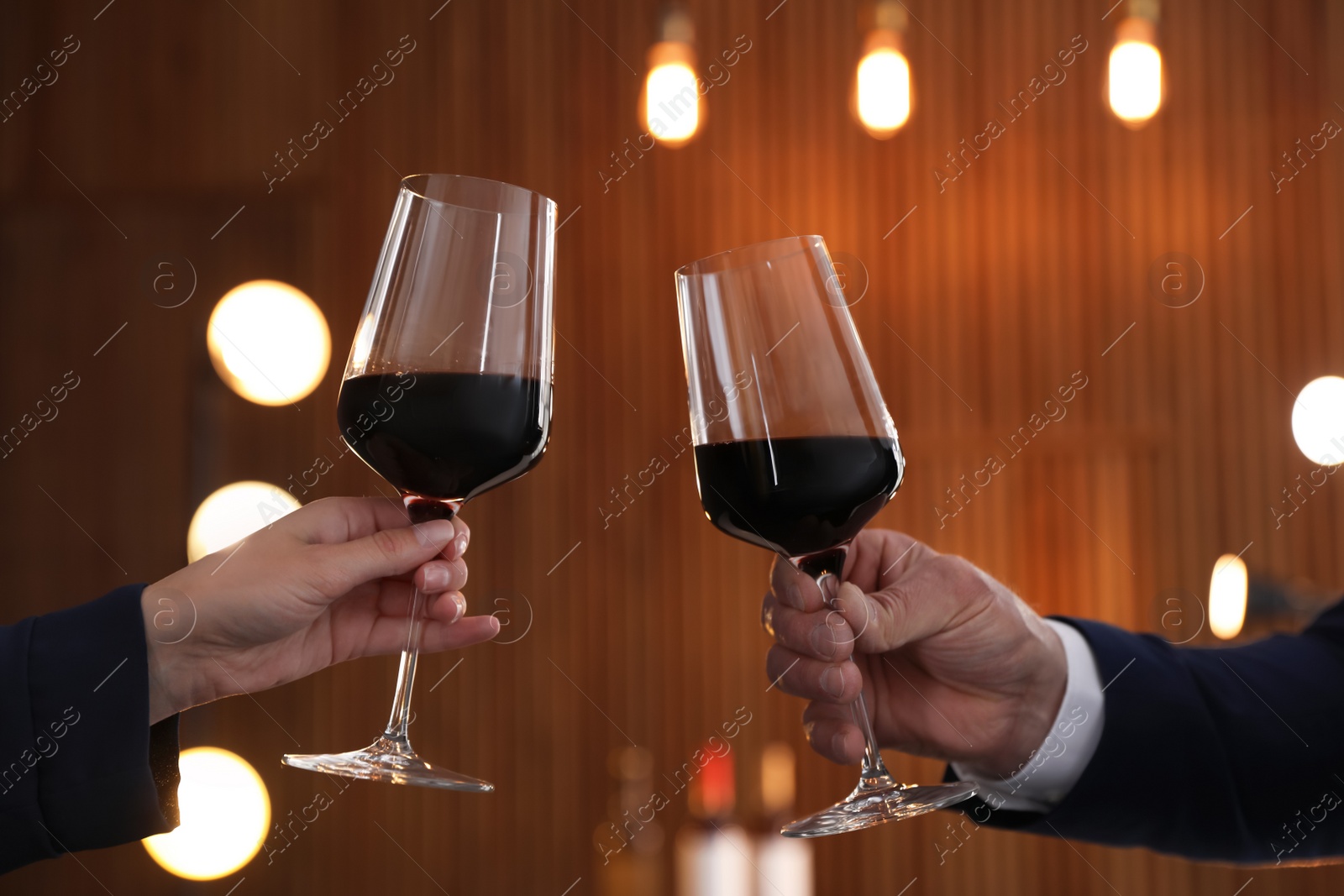 Photo of People with glasses of wine on blurred background, closeup