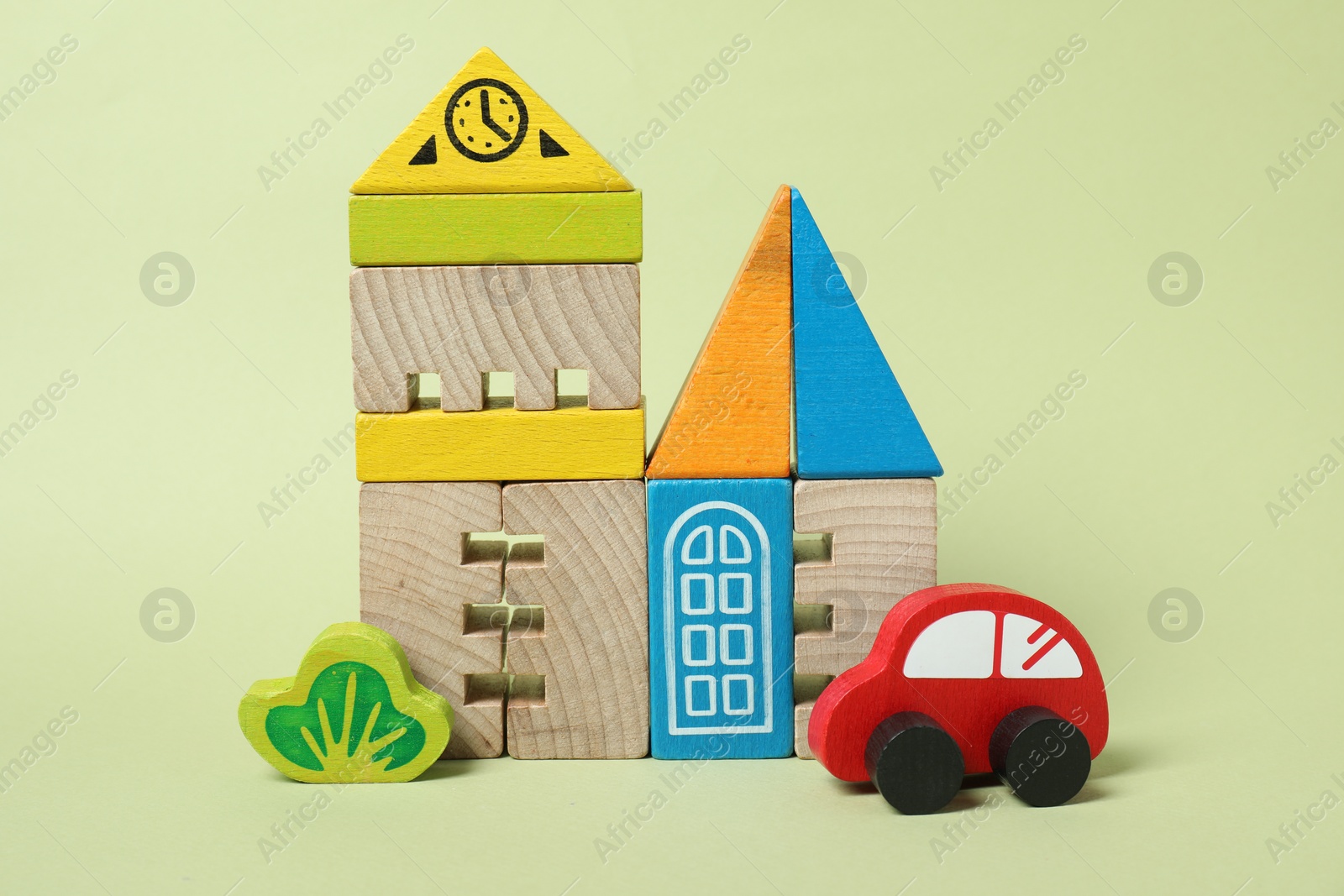 Photo of Set of wooden toys on pale light green background. Children's development