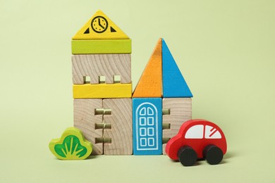 Set of wooden toys on pale light green background. Children's development