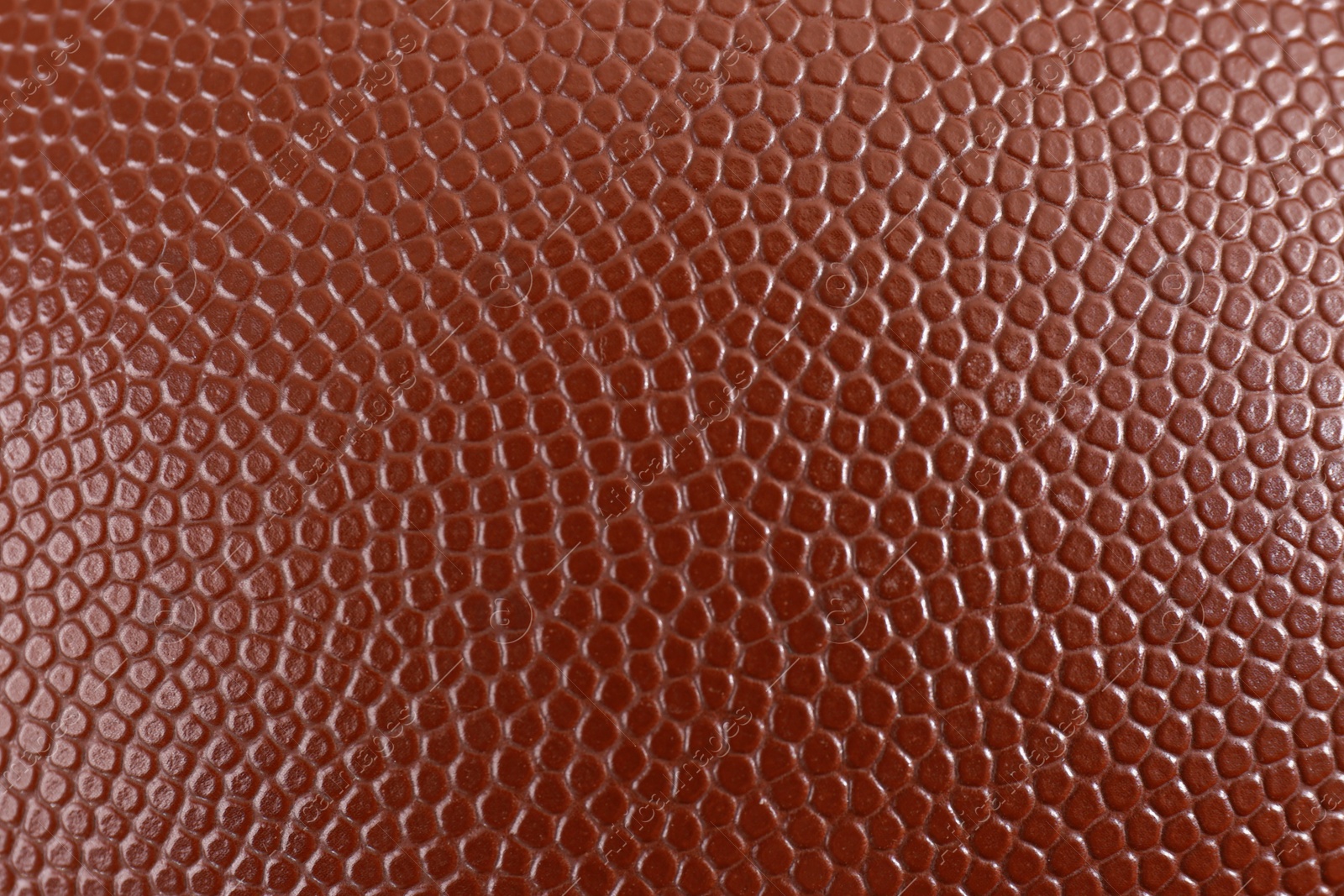 Photo of Texture of American football ball leather as background, closeup