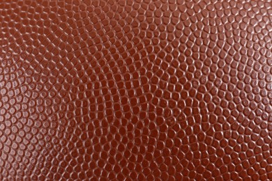 Texture of American football ball leather as background, closeup