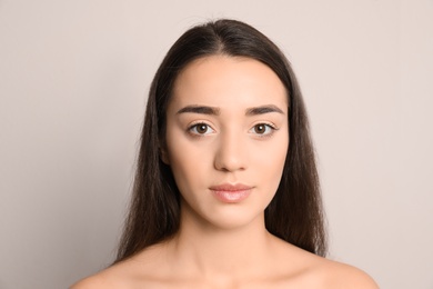 Photo of Portrait of young woman on light background